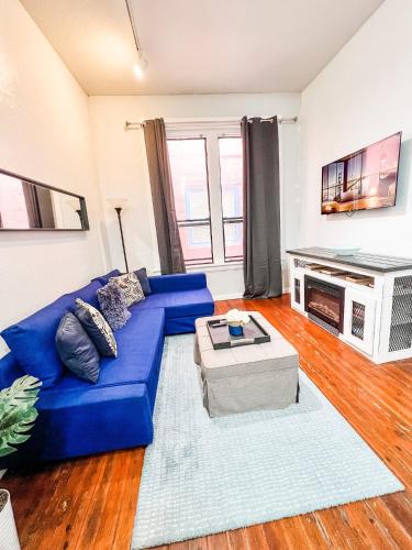 a living room with a blue couch and a tv at Gaslamp 2bdrm1ba - W Parking & 4 Beds #304 in San Diego