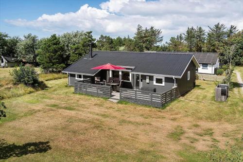 a house with a red roof in a yard at 1353-Snedsted-Ebenezervej-24 in Snedsted