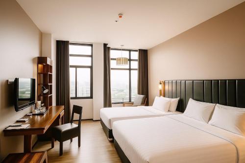 Ένα ή περισσότερα κρεβάτια σε δωμάτιο στο Grand Howard Hotel Bangkok
