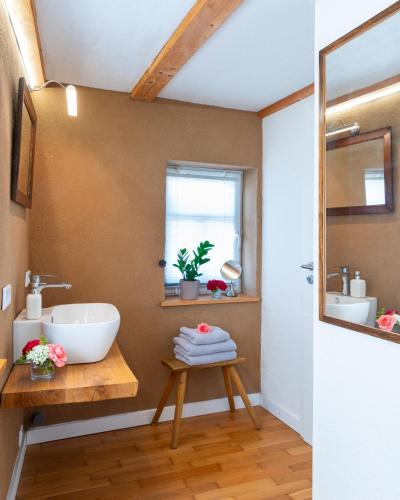 a bathroom with a sink and a window at Ferienappartement Enzianshaus in Höchheim