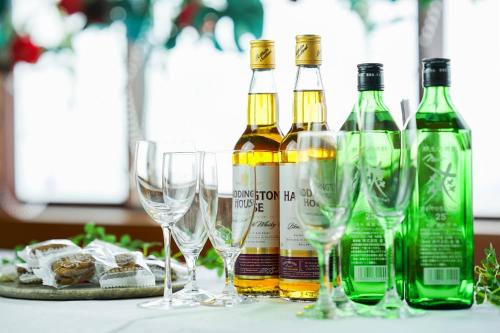 a group of wine bottles and glasses on a table at Yamagata Grand Hotel in Yamagata