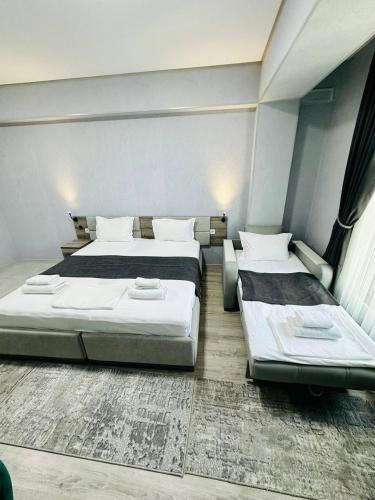 a bedroom with two beds in a room at Beshchinor Hotel in Yakkasaray