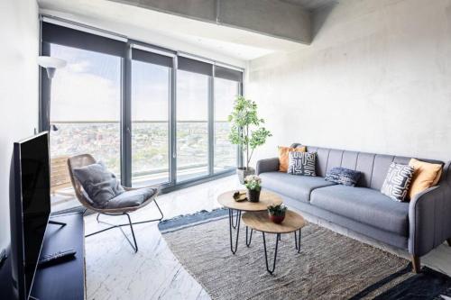 a living room with a couch and a tv at Gorgeous Modern 1bd Condo Views W Poolgym! #255 in Istanbul