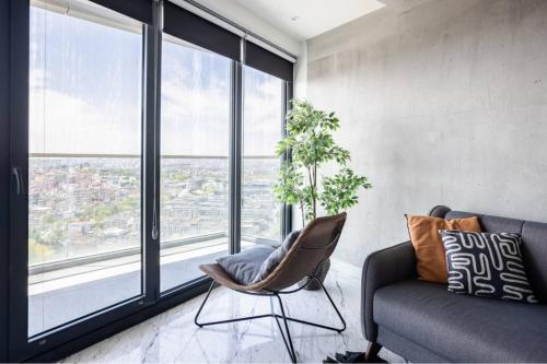 a living room with a couch and large windows at Gorgeous Modern 1bd Condo Views W Poolgym! #255 in Istanbul
