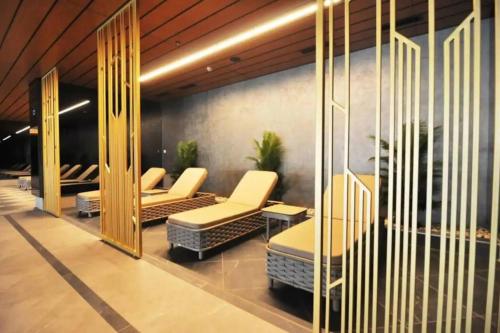 a waiting area with chairs and tables in a lobby at Gorgeous Modern 1bd Condo Views W Poolgym! #255 in Istanbul