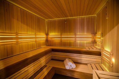 a wooden sauna with two towels sitting in it at Spa & Wellness Vila Antoaneta in Lázně Luhačovice