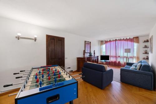 a living room with a table with a chessboard on it at Villa Alessandra in Pellio Inferiore