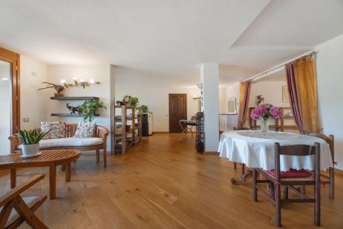 a living room with a table with flowers on it at Villa Alessandra in Pellio Inferiore