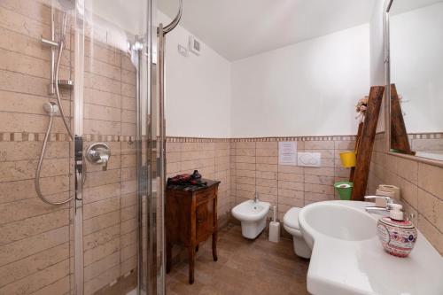a bathroom with a shower and a sink and a toilet at Villa Alessandra in Pellio Inferiore
