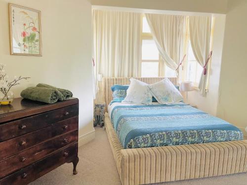 - une chambre avec un lit, une commode et une fenêtre dans l'établissement Hanami Place - Kandos - 4 bedroom house 1-8 people, à Kandos