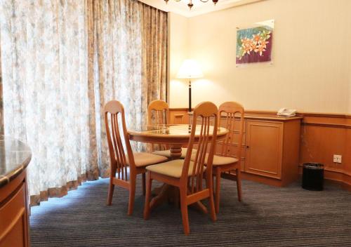 a dining room with a table and chairs at Grand Palace Hotel in Miri