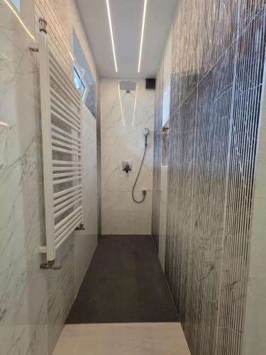 a bathroom with a shower and a walk in shower at Apartamenty KORONA in Krosno