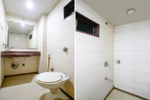 a bathroom with a toilet and a shower at FabExpress Guru Heritage in Navi Mumbai
