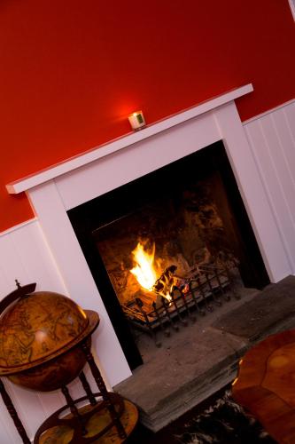 a fireplace with a fire in it with a fire at The Inn at Loch Tummel in Tummel Bridge