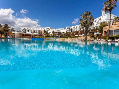 a large pool of blue water in front of a resort at Marina Smir Hotel & Spa in M'diq