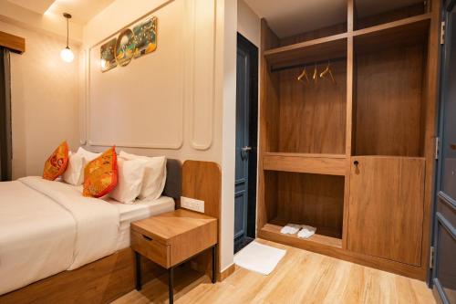 a small bedroom with a bed and a table at Hotel Lake Metro in Udaipur