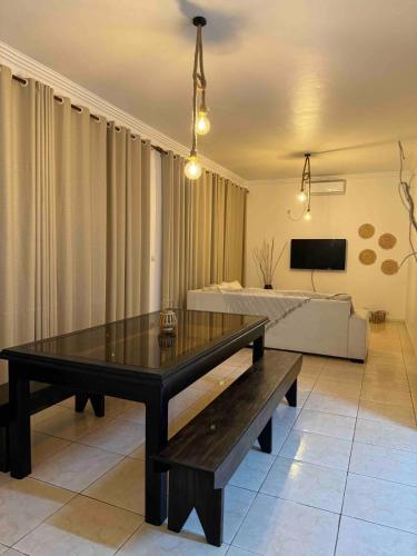 a living room with a table and a couch at Lar do Índico in Fombeni