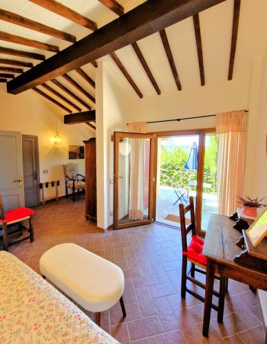 a room with a bed and a table and chairs at Borgo Melograno in Chiusi