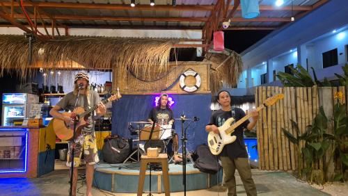 a group of people playing music on a stage at Camotes Hostel Resort in Camotes Islands