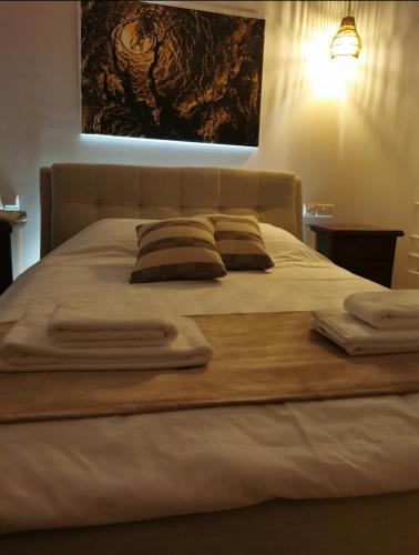 a large bed with two pillows on top of it at Daglas suit in Kannaviou