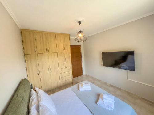 a bedroom with a bed and wooden cabinets in it at Spacious Modern Home in Kalpaki in Kalpákion