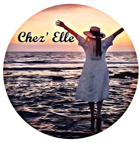 a woman standing on the beach with the words cheer like at Chez’ Elle in Blankenberge