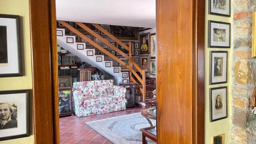 a living room with a staircase and a chair at Hotel Bolero in Sirmione