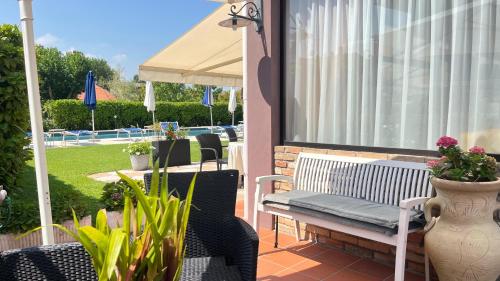a porch with a bench and a table and chairs at Hotel Bolero in Sirmione