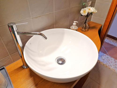 a white sink with a faucet in a bathroom at Borgo Melograno in Chiusi