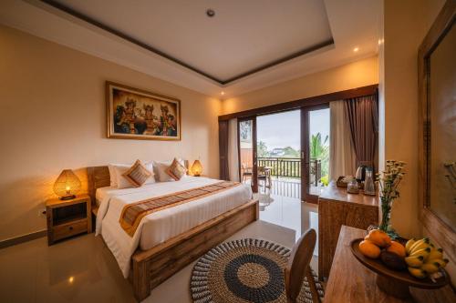 a hotel room with a bed and a balcony at Oka Suite Sebatu Ubud in Tampaksiring