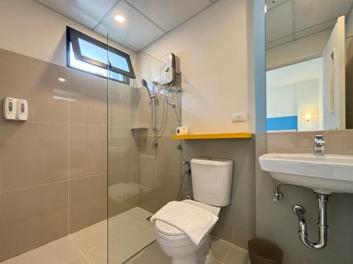 a bathroom with a toilet and a sink and a shower at HOP INN Phrae in Phrae