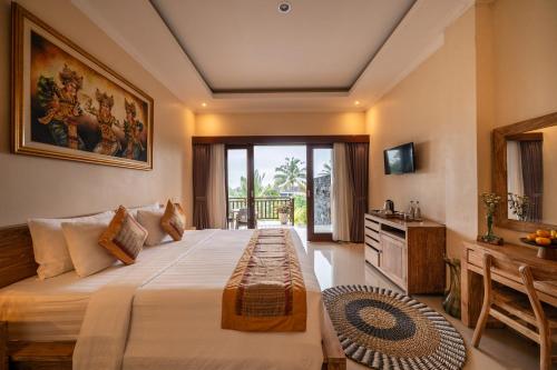 a bedroom with a large bed and a television at Oka Suite Sebatu Ubud in Tampaksiring