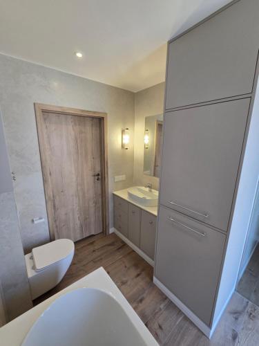 a bathroom with a toilet and a sink at Eko Osada Zacisze in Ostrowite