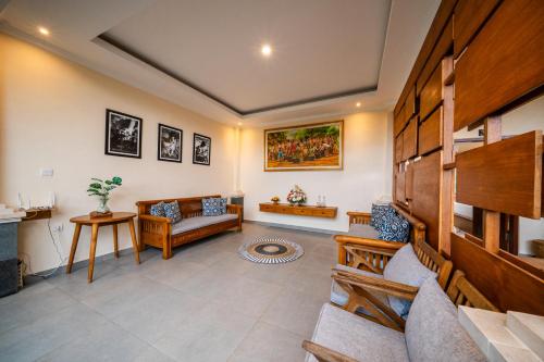 a living room with a couch and a table at Oka Suite Sebatu Ubud in Tampaksiring