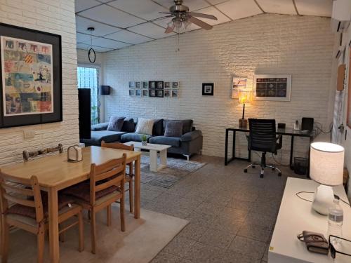 a living room with a couch and a table at La Cima House-Studio in San Salvador