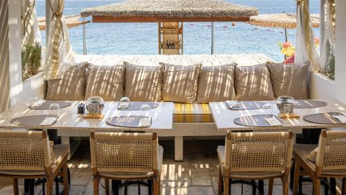 a restaurant with tables and chairs in front of the ocean at Swissôtel Living Bodrum in Bodrum City