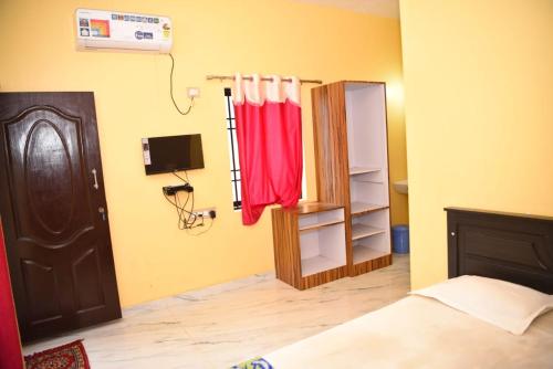 a bedroom with a bed and a red towel at Sharavathi Paradise in Kāsarkod
