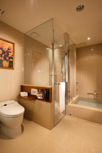 a bathroom with a toilet and a shower and a tub at San Want Residences Taipei in Taipei