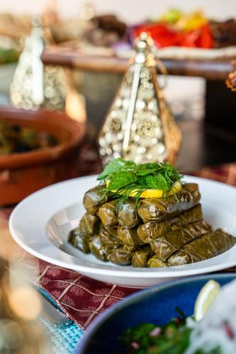 a plate of food with a pile of food at Wyndham Residences The Palm in Dubai