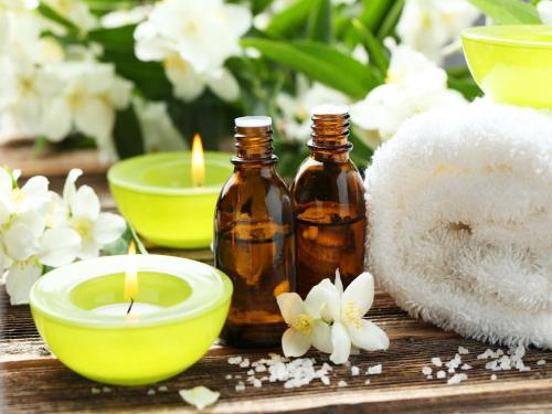 a table with two bottles of essential oils and candles at Marina Smir Hotel & Spa in M'diq