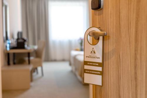 a sign on a door in a hotel room at Spa Hotel Persenk in Devin