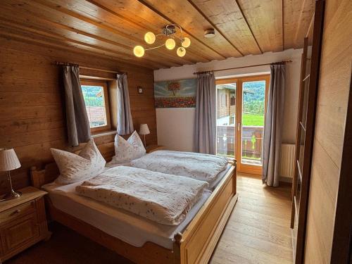 a bedroom with a large bed in a wooden room at Gästehaus Binderlehen in Schönau am Königssee