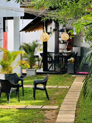 a patio with two chairs and a table at Traget safari home stay in Udawalawe