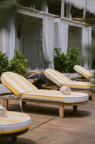 a row of lounge chairs sitting on a deck at Swissôtel Living Bodrum in Bodrum City