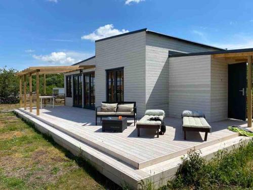 a wooden deck with furniture and a house at Wonderful summer place in beautiful Köpingsvik, Borgholm in Köpingsvik