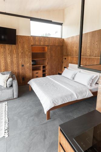 a bedroom with a large bed and a television at Krasnyk Resort in Krasnik