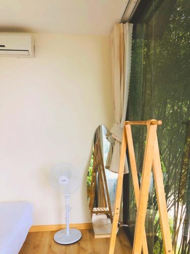 a room with a ladder and a glass window at Dreamy Homestay Tam Đảo in Tam Ðảo