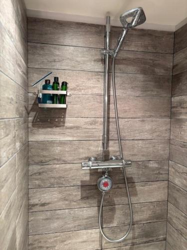 a shower with a shower head in a bathroom at La Maison des Cordiers in Dinan