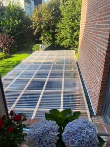 a patio with a lot of solar panels and flowers at Appartementhaus EMDEN in Emden