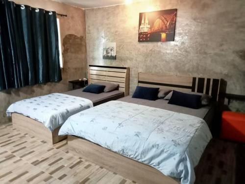 two beds in a room with two beds sidx sidx sidx sidx at Ingna Resort in Chanuman